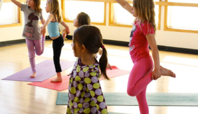 Kids yoga class in a bright room.
