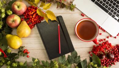 Notebook, pencil, fruit, tea, and laptop.